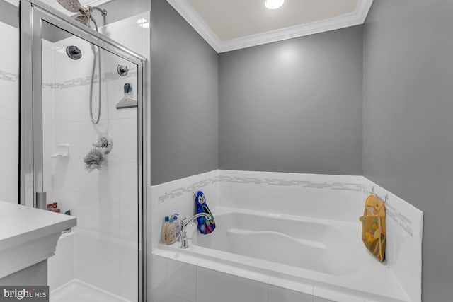 bathroom featuring a garden tub, a shower stall, crown molding, and vanity