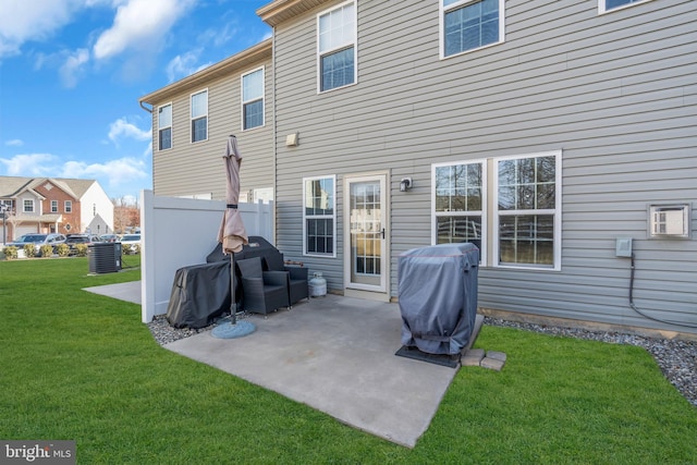 back of property featuring a patio and a lawn