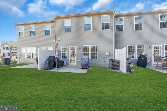 back of house featuring a patio, central AC unit, a lawn, and fence