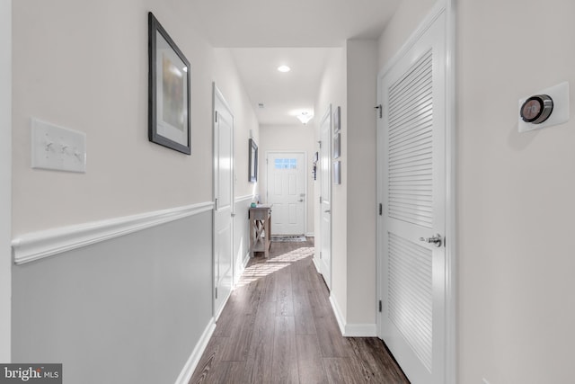 corridor with baseboards, dark wood-style flooring, and recessed lighting