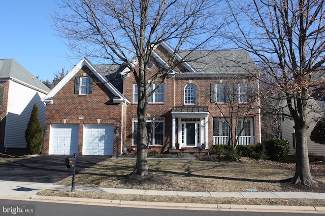 view of front of property with brick siding, driveway, and an attached garage