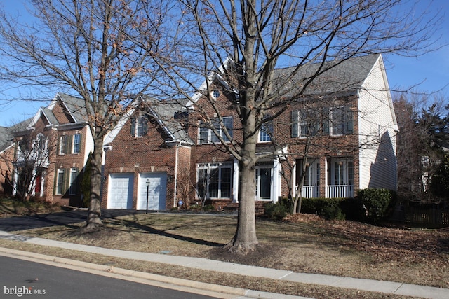 view of front of home with a garage, aphalt driveway, and brick siding