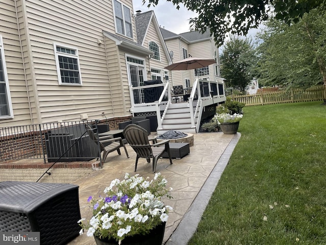 view of patio / terrace featuring fence, a fire pit, and a wooden deck