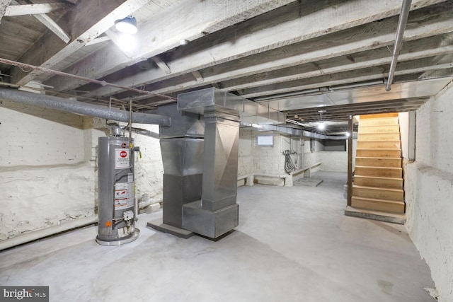 basement featuring stairway, gas water heater, and heating unit