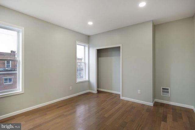 unfurnished bedroom with recessed lighting, wood finished floors, visible vents, and baseboards