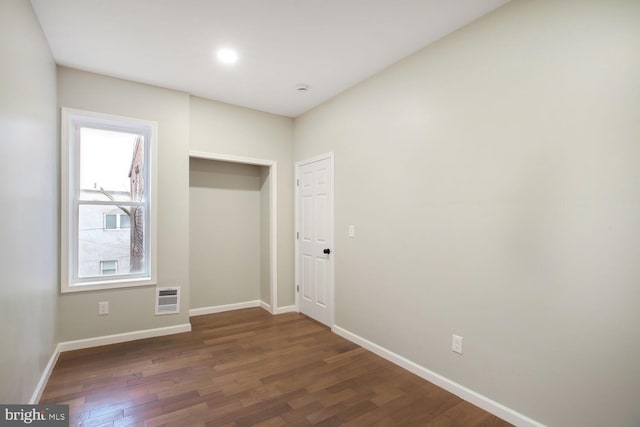 unfurnished room with wood finished floors and baseboards