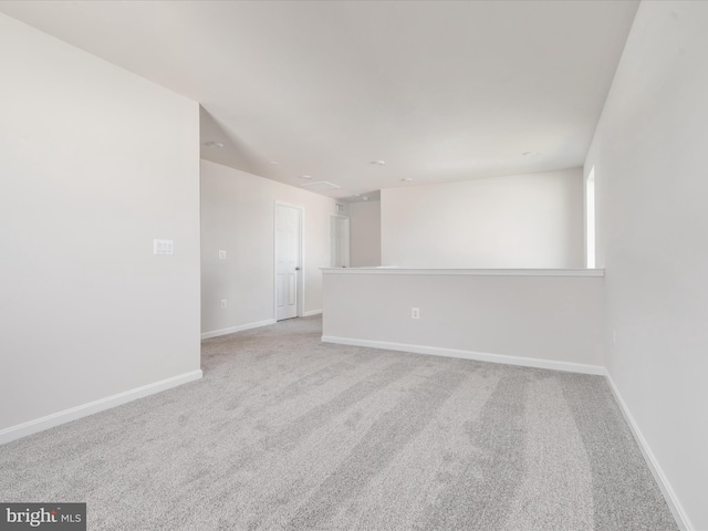 empty room with light colored carpet and baseboards