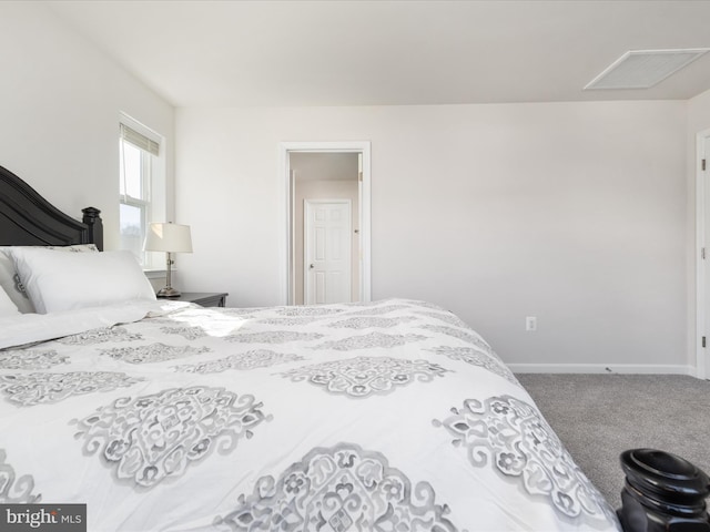 carpeted bedroom with visible vents and baseboards