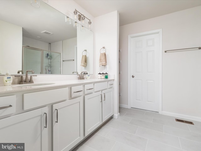 full bathroom with double vanity, a sink, and visible vents