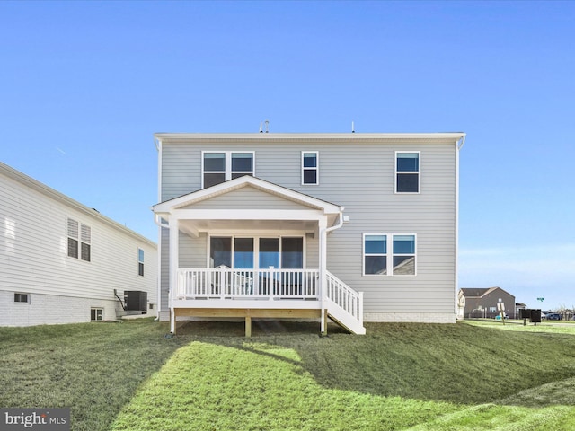 back of house featuring covered porch, central AC, and a yard