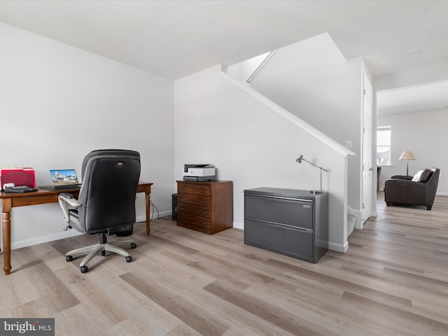 office area with light wood-type flooring and baseboards