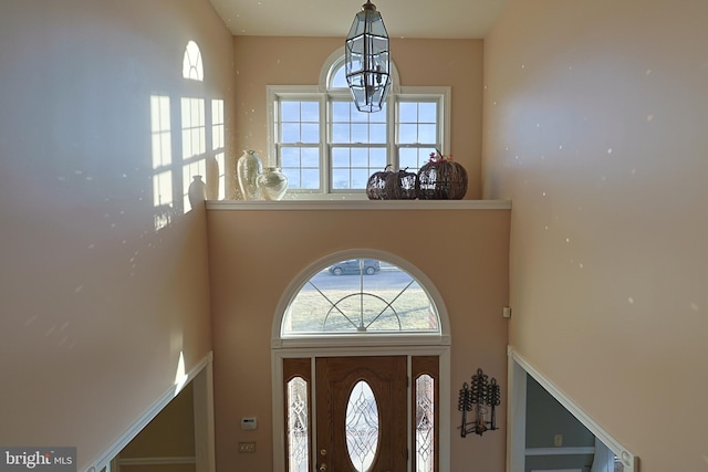 foyer featuring a high ceiling and a chandelier