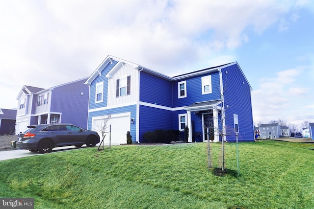 traditional-style home featuring a front yard, driveway, and an attached garage