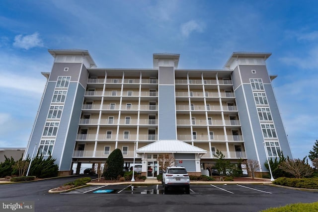 view of building exterior featuring uncovered parking