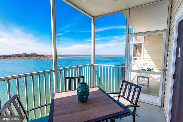 unfurnished sunroom featuring a water view and a wealth of natural light