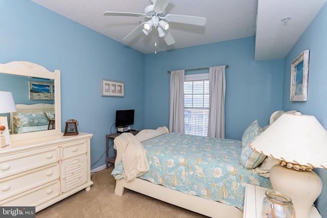 bedroom with a ceiling fan and light carpet