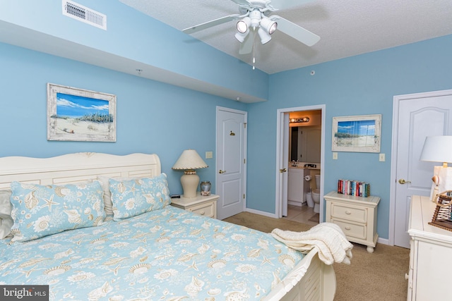 bedroom featuring light colored carpet, visible vents, connected bathroom, and baseboards