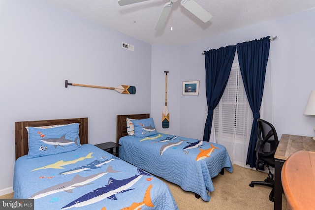 bedroom with ceiling fan, a textured ceiling, visible vents, and carpet flooring