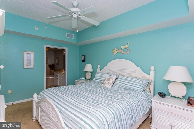 bedroom with a textured ceiling, baseboards, visible vents, and light colored carpet