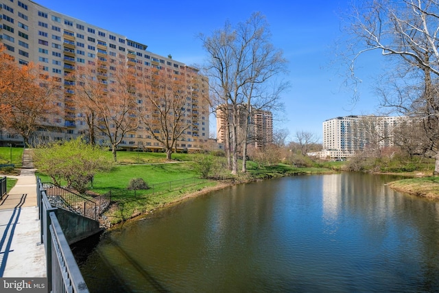 property view of water featuring a view of city and fence