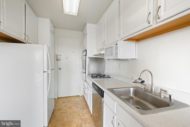 kitchen featuring stainless steel appliances, a sink, white cabinetry, light countertops, and range hood