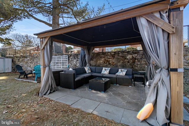 view of patio / terrace with fence, outdoor lounge area, and a gazebo