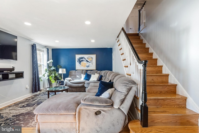 living room featuring stairs, baseboards, and recessed lighting