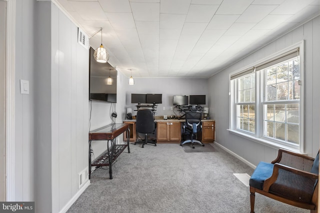 office space with light carpet, visible vents, and baseboards