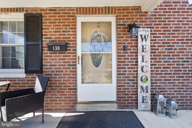 property entrance featuring brick siding