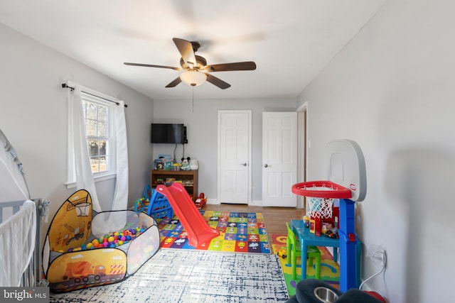 game room featuring ceiling fan, baseboards, and wood finished floors