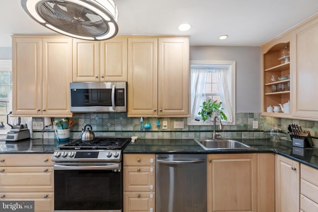 kitchen featuring decorative backsplash, appliances with stainless steel finishes, light brown cabinetry, open shelves, and a sink