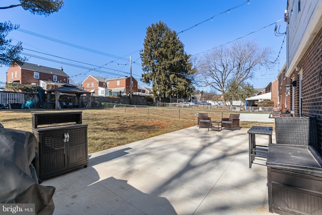 view of patio / terrace with a gazebo, a fenced backyard, and a residential view