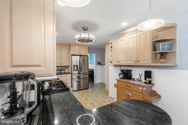 kitchen with dark countertops, stainless steel fridge, light brown cabinets, and open shelves