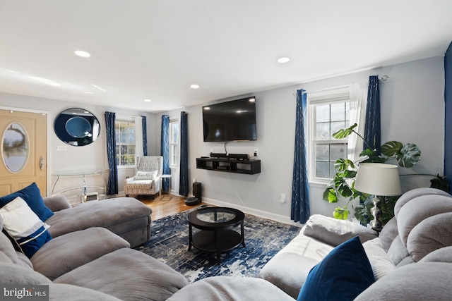 living area featuring recessed lighting, wood finished floors, and baseboards