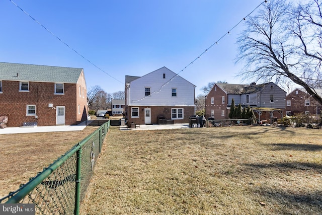 exterior space featuring a yard, a patio area, a fenced backyard, and a residential view