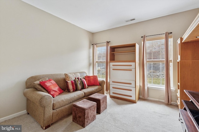 living room featuring carpet floors, visible vents, and baseboards