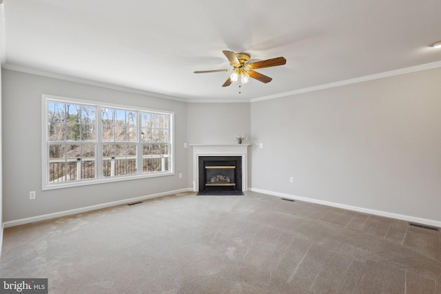 unfurnished living room with carpet, visible vents, baseboards, a fireplace with flush hearth, and ornamental molding