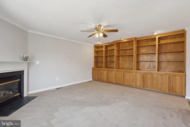 unfurnished living room with crown molding, a fireplace with flush hearth, light colored carpet, and baseboards