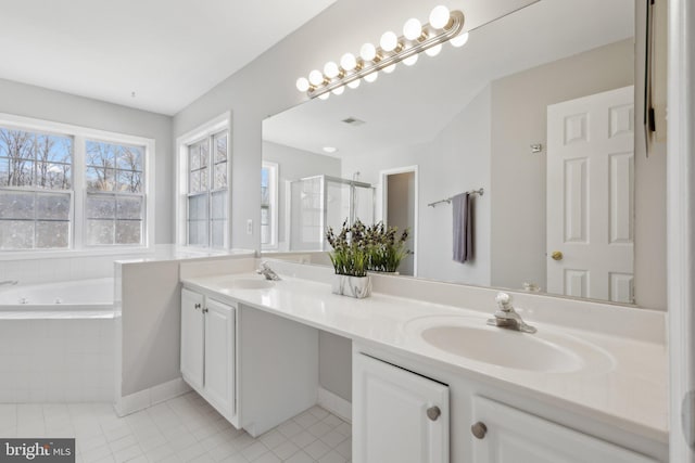 full bath featuring a sink, a garden tub, a stall shower, and double vanity