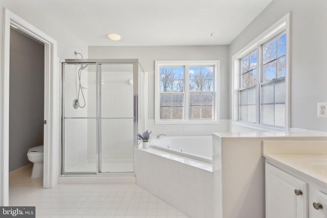 full bathroom featuring tile patterned floors, a shower stall, toilet, and a garden tub