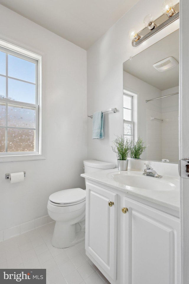 full bath with tile patterned floors, toilet, baseboards, walk in shower, and vanity