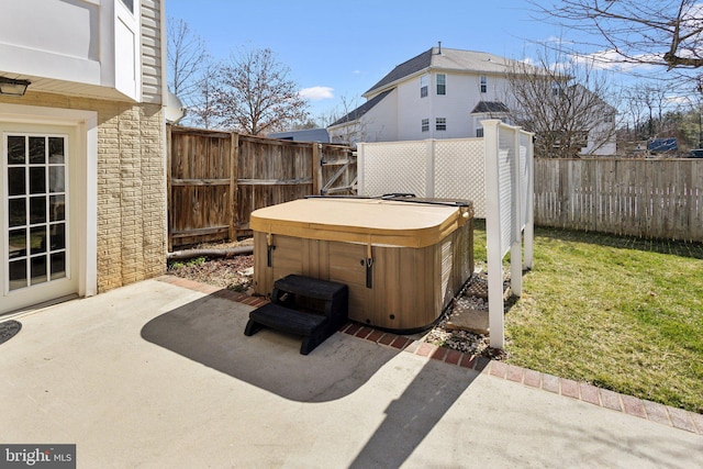 view of patio / terrace with a hot tub and a fenced backyard