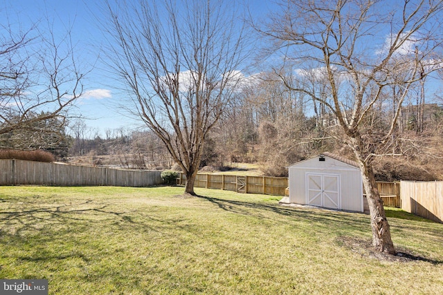 view of yard with a fenced backyard, a shed, and an outdoor structure