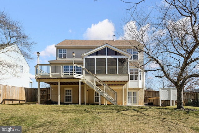 back of house featuring stairway, a fenced backyard, a sunroom, and a wooden deck