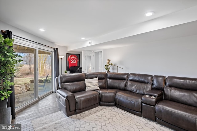 living area featuring light wood-type flooring, visible vents, and recessed lighting