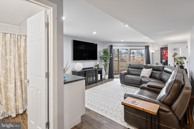 living area with recessed lighting and wood tiled floor