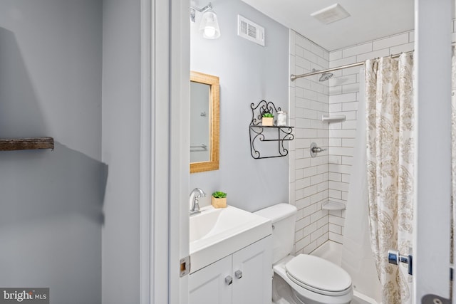 full bath featuring toilet, vanity, a shower stall, and visible vents