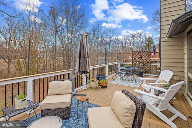 wooden terrace featuring outdoor dining space