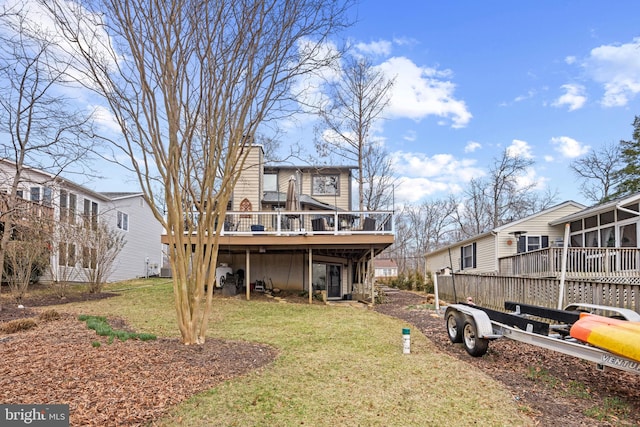 rear view of property featuring a lawn, a sunroom, a chimney, a residential view, and a deck