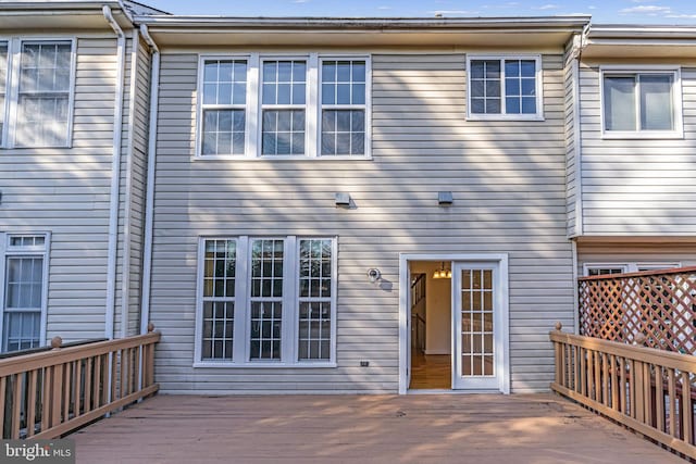 rear view of property featuring a deck